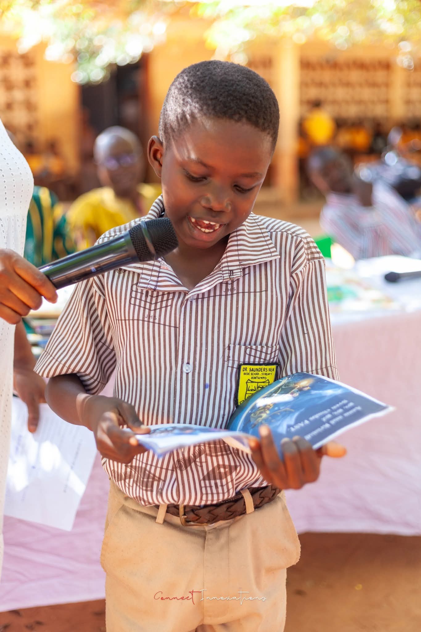 A pupil from Dr. Saunders Memorial School reading a donated book