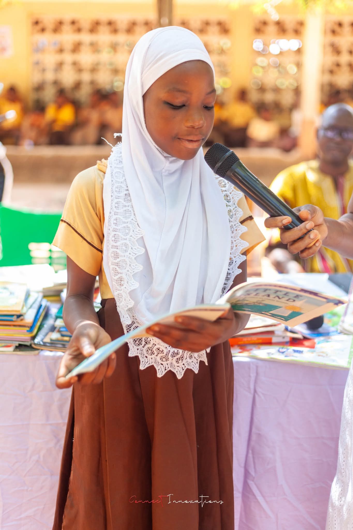 A student reading aloud from a book at the Kintampo book club launch