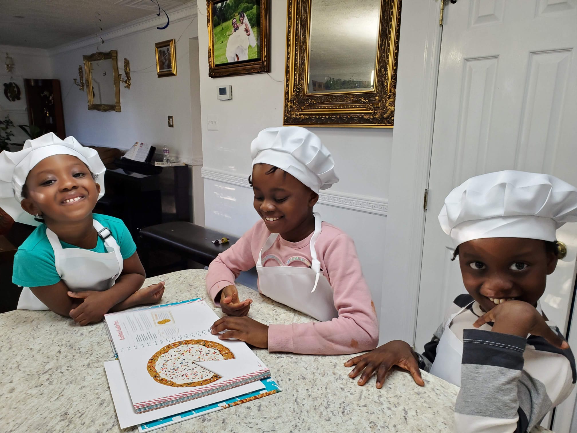 Myra, Mev III, and Xine — the three siblings behind the book drive initiative
